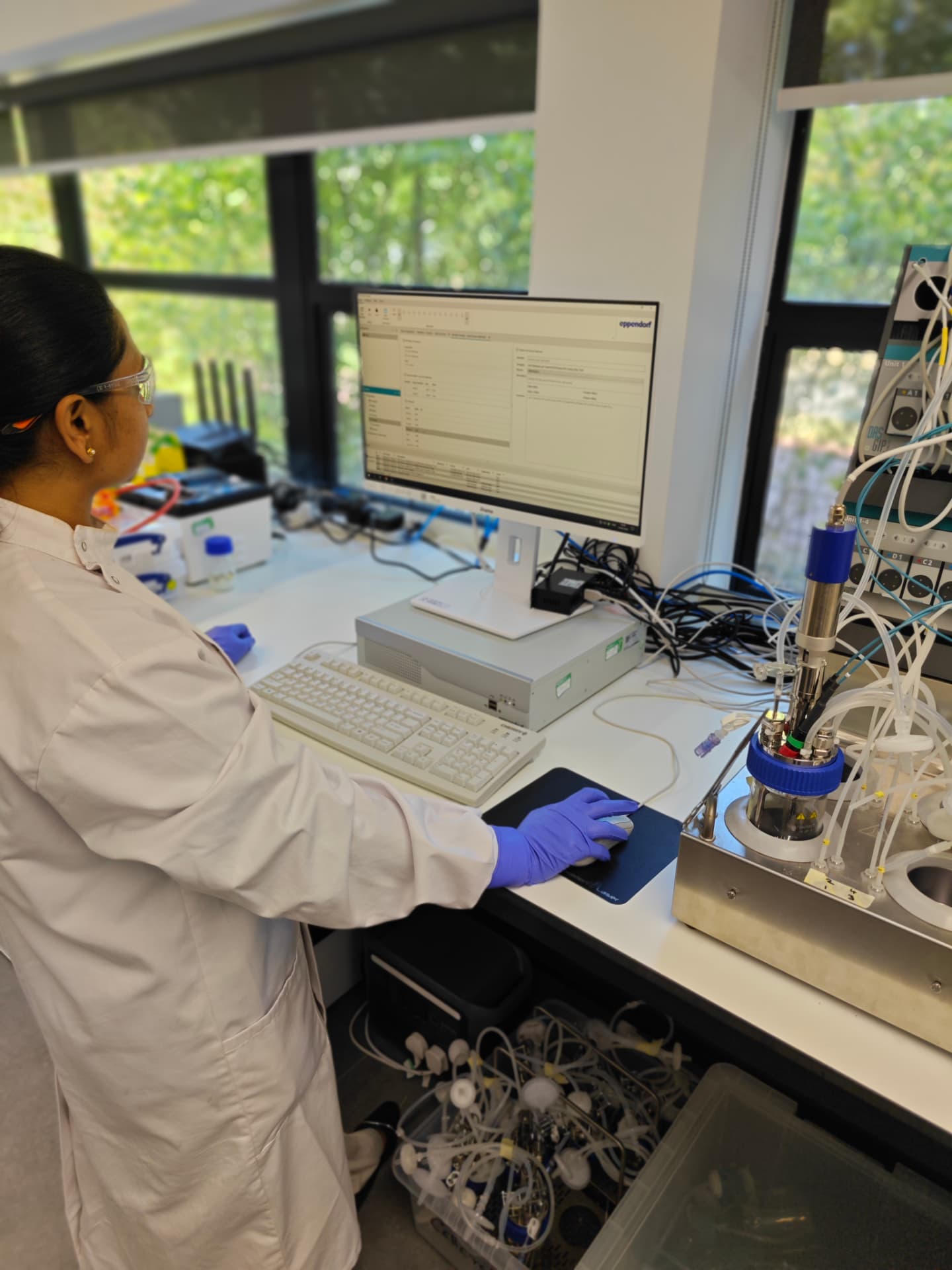 Cellcraft researcher operating a bioreactor in the Cambridge laboratory